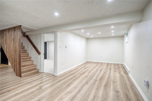 2425 W Pike St, Chartiers, PA 15342 - finished basement with a baseboard heating unit, wood finished floors, recessed lighting, stairs, and a textured ceiling