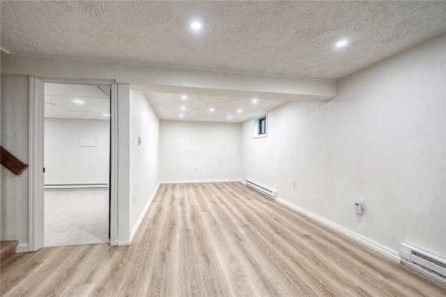 2425 W Pike St, Chartiers, PA 15342 - finished below grade area with baseboard heating, light wood-style flooring, recessed lighting, and baseboards