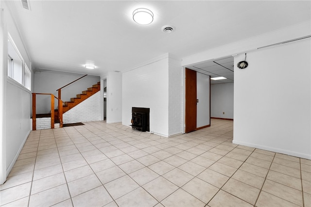 121 Edgar Ln, Peters Twp, PA 15367 - unfurnished room with baseboards, stairway, a wood stove, and light tile patterned floors