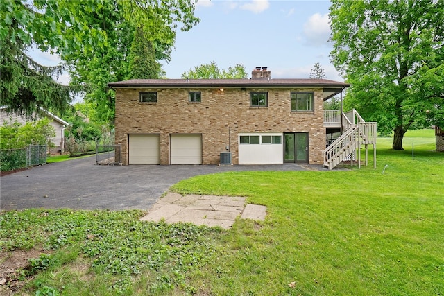 121 Edgar Ln, Peters Twp, PA 15367 - rear view of house with a garage, stairway, brick siding, a chimney, and driveway