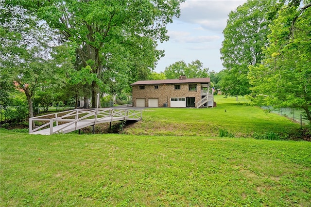 121 Edgar Ln, Peters Twp, PA 15367 - view of grassy yard with stairway, an attached garage, driveway, and view of scattered trees