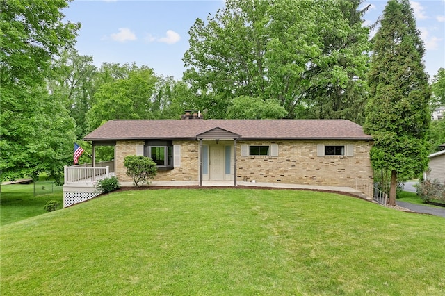 121 Edgar Ln, Peters Twp, PA 15367 - view of front facade featuring brick siding, a front yard, a chimney, and a shingled roof