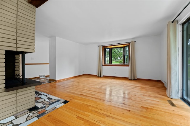 121 Edgar Ln, Peters Twp, PA 15367 - unfurnished living room featuring a brick fireplace, light wood finished floors, and baseboards
