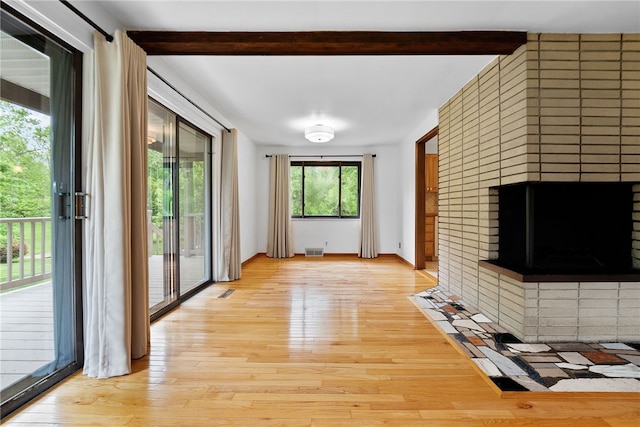 121 Edgar Ln, Peters Twp, PA 15367 - unfurnished living room with beamed ceiling, light wood-style floors, a brick fireplace, and baseboards