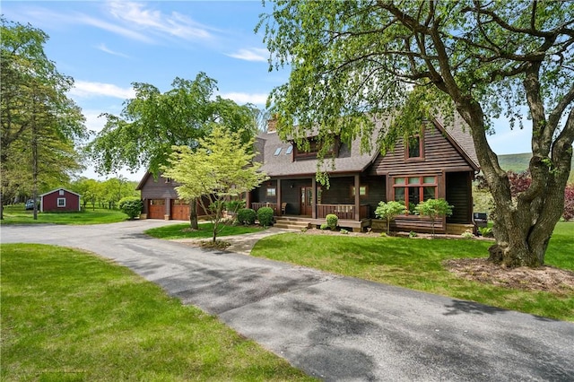 311 Derry Ridge Rd, Ligonier Twp, PA 15658 - view of front facade featuring covered porch, a garage, a front yard, and roof with shingles