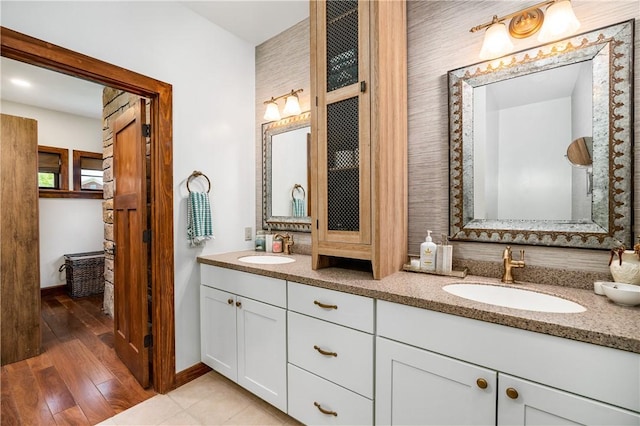 311 Derry Ridge Rd, Ligonier Twp, PA 15658 - bathroom with double vanity, baseboards, and wood finished floors