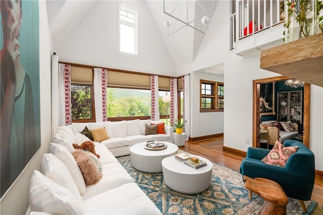 311 Derry Ridge Rd, Ligonier Twp, PA 15658 - living area with a chandelier, wood finished floors, high vaulted ceiling, and baseboards