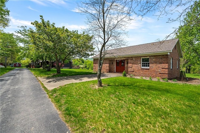 311 Derry Ridge Rd, Ligonier Twp, PA 15658 - view of front facade with brick siding, a front lawn, a shingled roof, and driveway