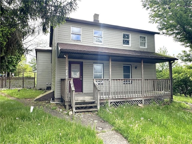 305 3rd St, Unity Twp, PA 15638 - view of front of house with a porch and a chimney