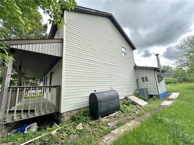 305 3rd St, Unity Twp, PA 15638 - view of side of property with oil tank, a wooden deck, and cooling unit