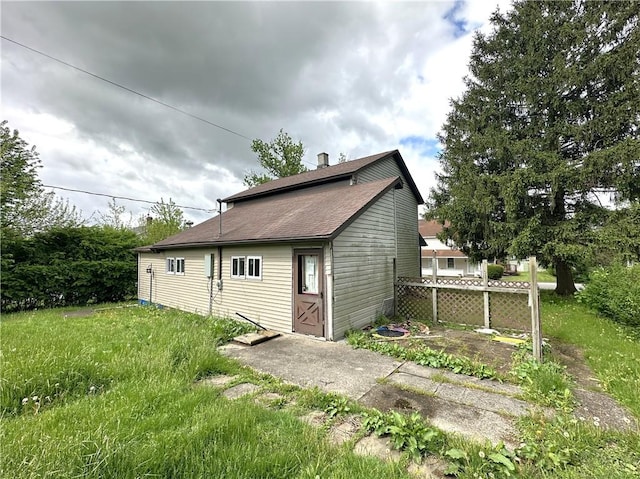 305 3rd St, Unity Twp, PA 15638 - back of property featuring a chimney and roof with shingles