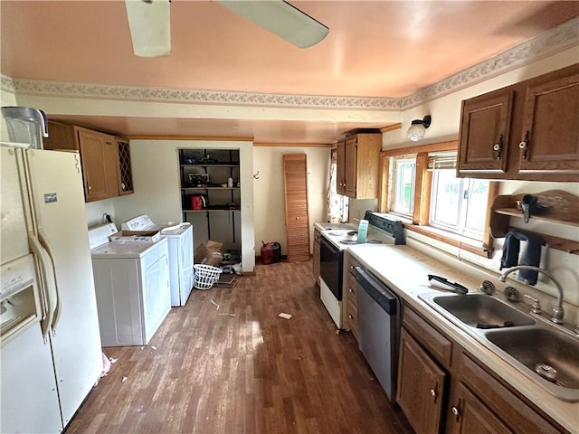 305 3rd St, Unity Twp, PA 15638 - kitchen featuring white appliances, washer and dryer, a sink, dark wood finished floors, and light countertops