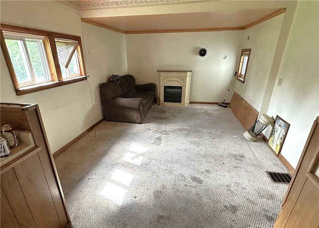 305 3rd St, Unity Twp, PA 15638 - unfurnished living room featuring light colored carpet, a glass covered fireplace, crown molding, and baseboards