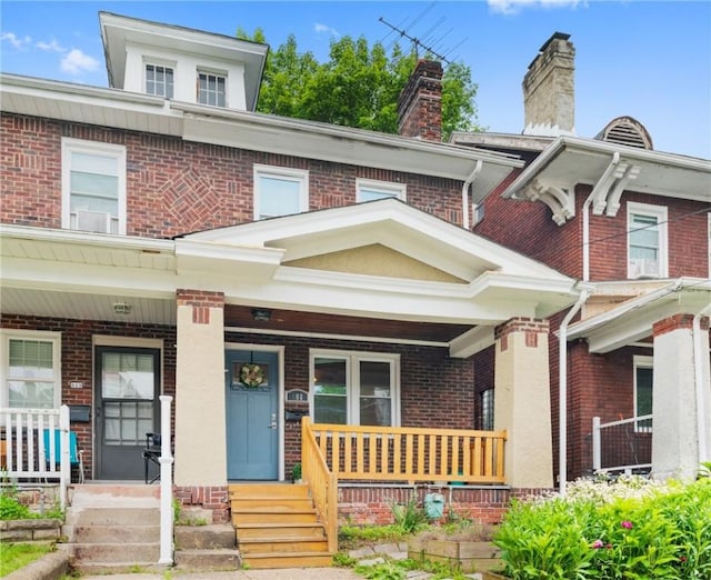 908 N Saint Clair St, Highland Park, PA 15206 - traditional style home with brick siding, covered porch, and a chimney