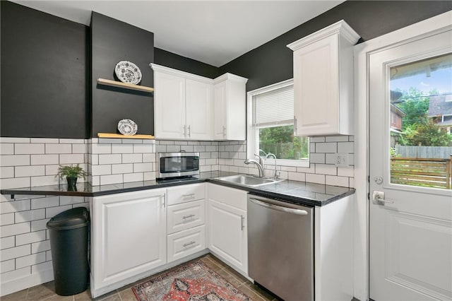 908 N Saint Clair St, Highland Park, PA 15206 - kitchen with stainless steel appliances, a sink, open shelves, dark countertops, and white cabinetry
