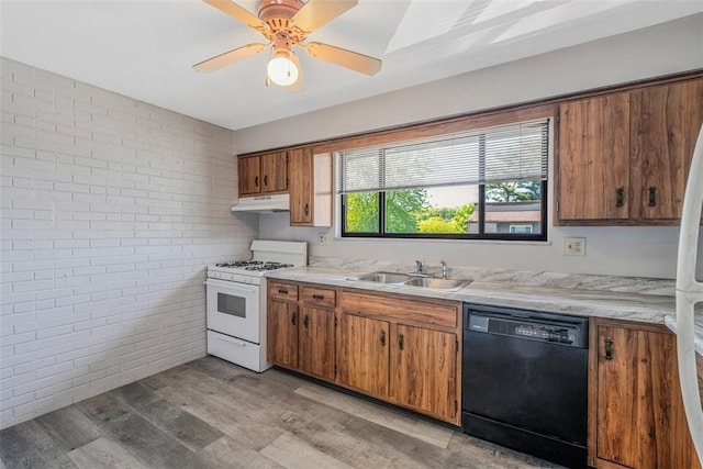 3143 Camberly Dr, Hampton, PA 15044 - kitchen with black dishwasher, white range with gas cooktop, brick wall, under cabinet range hood, and a sink