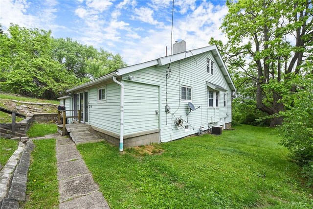 1030 N Grandview Ave, Mckeesport, PA 15132 - view of home's exterior featuring a chimney, a yard, and central AC