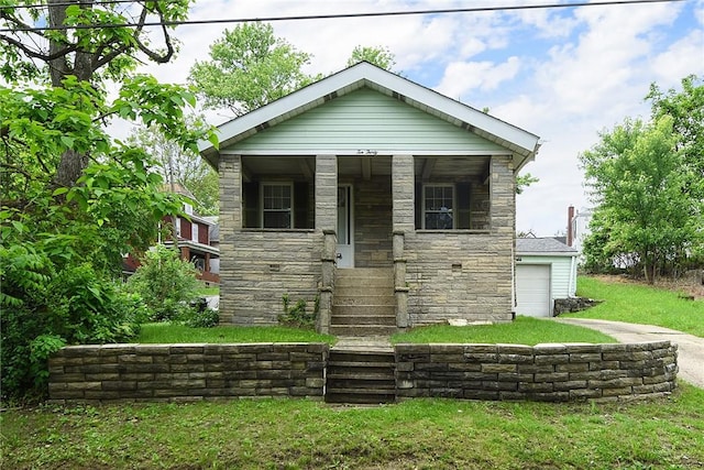 1030 N Grandview Ave, Mckeesport, PA 15132 - view of front of property with stone siding, concrete driveway, a porch, a front yard, and an attached garage