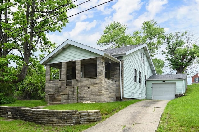 1030 N Grandview Ave, Mckeesport, PA 15132 - view of front of property with stone siding, driveway, a front lawn, an attached garage, and covered porch