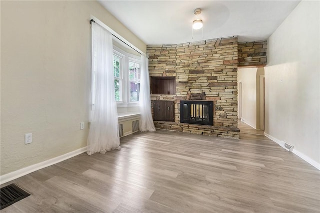 1030 N Grandview Ave, Mckeesport, PA 15132 - unfurnished living room featuring a fireplace, wood finished floors, and baseboards
