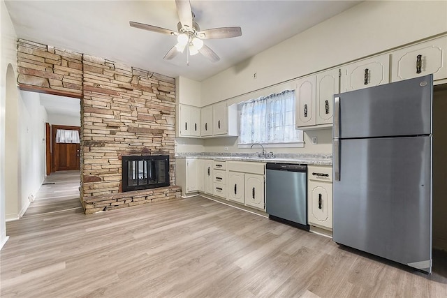 1030 N Grandview Ave, Mckeesport, PA 15132 - kitchen featuring appliances with stainless steel finishes, light countertops, white cabinets, ceiling fan, and light wood finished floors