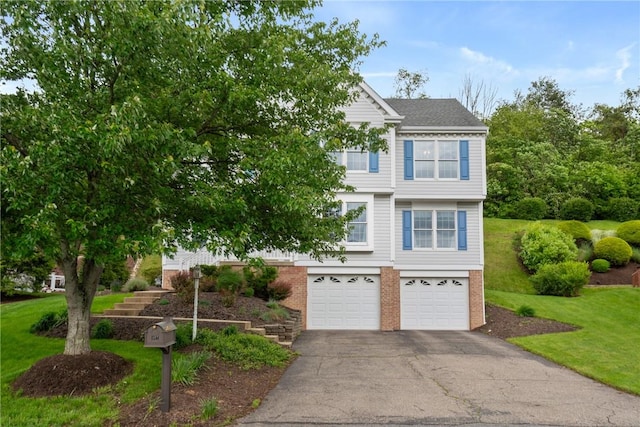 407 Pine Trees Dr, Scott Twp Sal, PA 15106 - view of front facade featuring an attached garage, asphalt driveway, brick siding, and a front yard