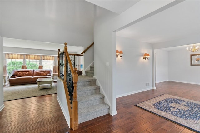 407 Pine Trees Dr, Scott Twp Sal, PA 15106 - stairs featuring wood finished floors, baseboards, and a chandelier