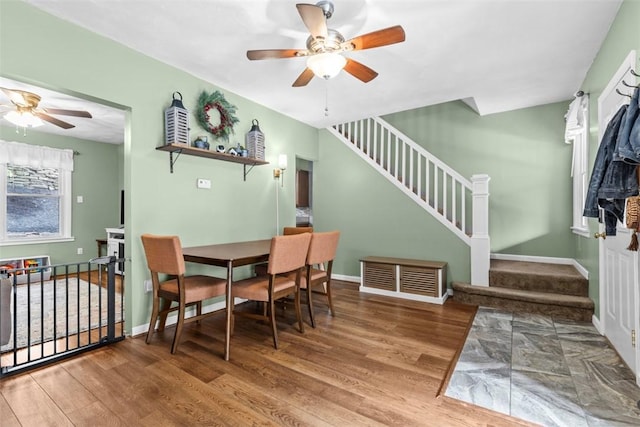 1241 Arkansas Ave, Dormont, PA 15216 - dining space featuring a ceiling fan, wood finished floors, stairway, and baseboards