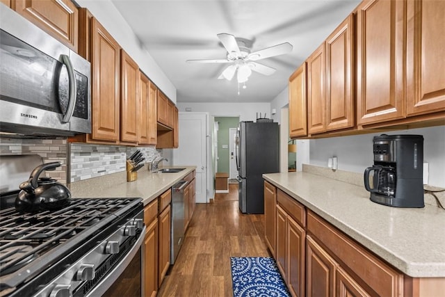 1241 Arkansas Ave, Dormont, PA 15216 - kitchen featuring appliances with stainless steel finishes, dark wood-style floors, a ceiling fan, tasteful backsplash, and light countertops
