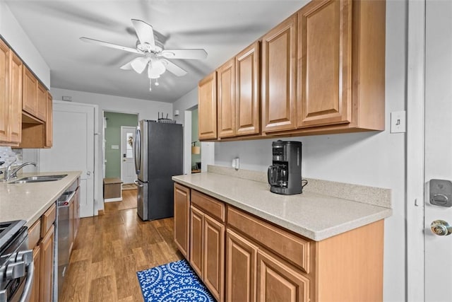 1241 Arkansas Ave, Dormont, PA 15216 - kitchen with stainless steel appliances, a sink, a ceiling fan, and wood finished floors
