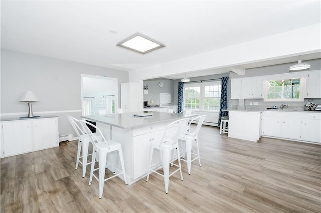 3 Coates Ln, White Twp Ind, PA 15701 - kitchen featuring light countertops, light wood-style flooring, and a breakfast bar area