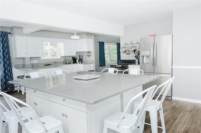 3 Coates Ln, White Twp Ind, PA 15701 - kitchen with stainless steel refrigerator with ice dispenser, light wood finished floors, light countertops, and white cabinetry