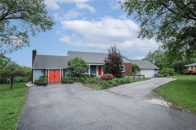 3 Coates Ln, White Twp Ind, PA 15701 - view of front of property with a chimney, a front lawn, and asphalt driveway