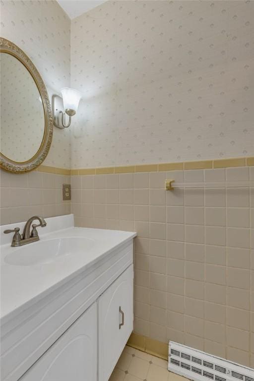 136 Upland Dr, Industry, PA 15052 - bathroom with wallpapered walls, vanity, a baseboard radiator, tile walls, and wainscoting