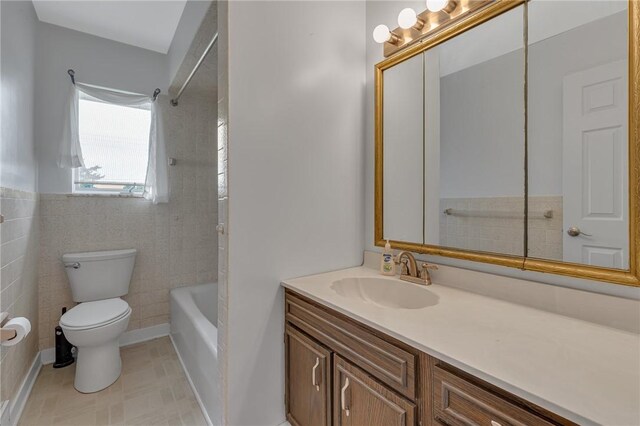 136 Upland Dr, Industry, PA 15052 - full bath featuring toilet, vanity, shower / bath combination, and tile walls