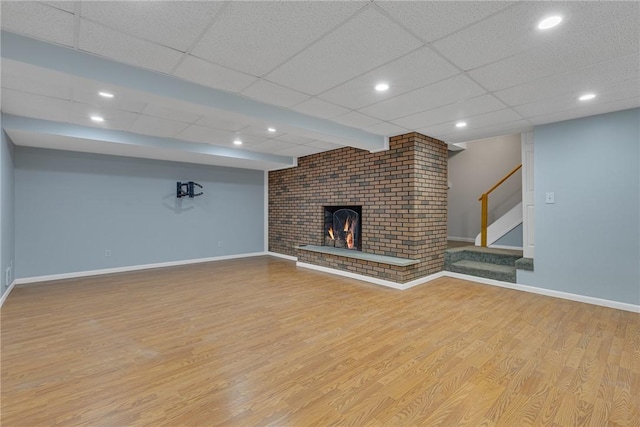 136 Upland Dr, Industry, PA 15052 - unfurnished living room featuring wood finished floors, baseboards, stairs, and a paneled ceiling