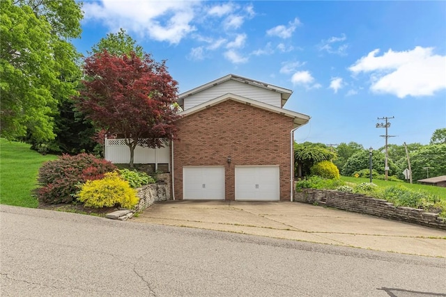 136 Upland Dr, Industry, PA 15052 - view of property exterior featuring brick siding, concrete driveway, and a garage