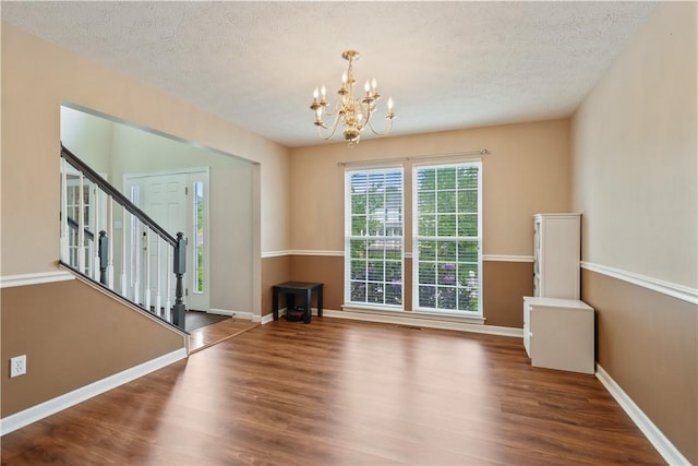 5109 Forest Ridge Dr, South Fayette, PA 15057 - empty room with wood finished floors, a chandelier, stairs, a textured ceiling, and baseboards