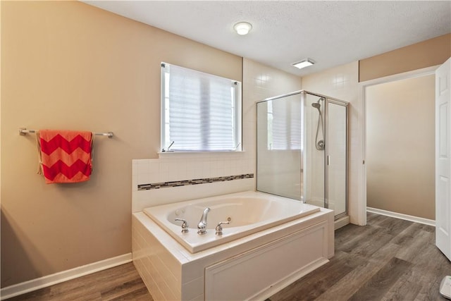 5109 Forest Ridge Dr, South Fayette, PA 15057 - bathroom featuring a shower stall, a bath, wood finished floors, baseboards, and a textured ceiling