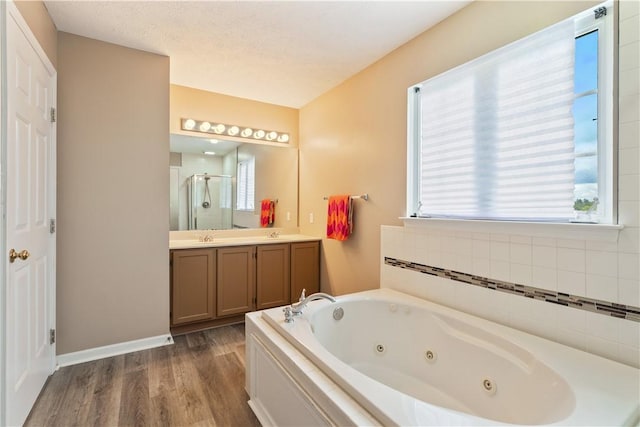 5109 Forest Ridge Dr, South Fayette, PA 15057 - full bathroom with a stall shower, a jetted tub, double vanity, wood finished floors, and baseboards