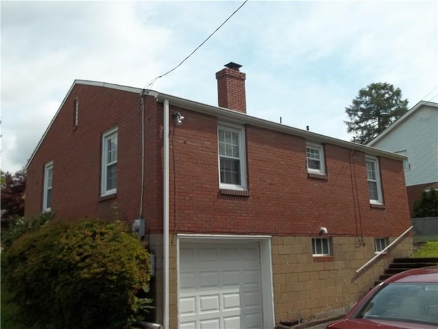 109 Mason Dr, Shaler, PA 15116 - view of side of property featuring a chimney, brick siding, an attached garage, and stairway