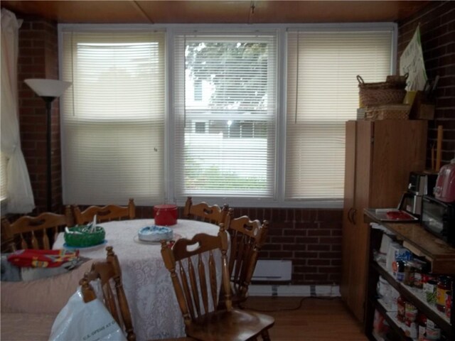 109 Mason Dr, Shaler, PA 15116 - dining area featuring wood finished floors, healthy amount of natural light, and brick wall