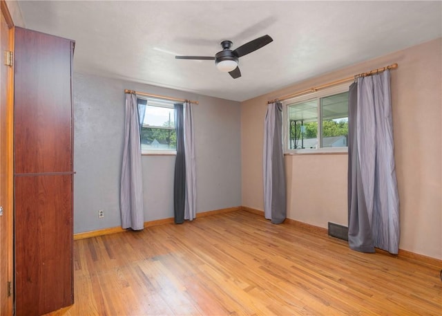 104 Neville, New Eagle, PA 15067 - unfurnished bedroom featuring multiple windows, light wood-type flooring, baseboards, and a ceiling fan