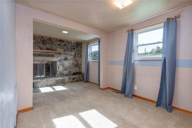 104 Neville, New Eagle, PA 15067 - unfurnished living room with carpet floors, baseboards, and a stone fireplace