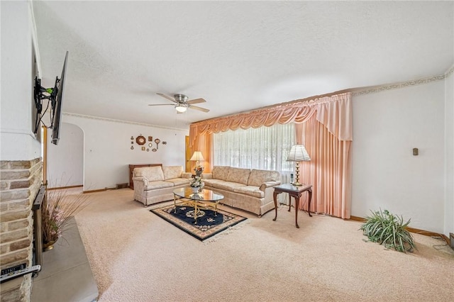 621 Kimlyn Ave, North Huntingdon, PA 15642 - carpeted living room with a ceiling fan, arched walkways, a textured ceiling, and baseboards