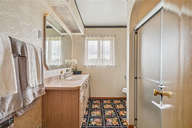 621 Kimlyn Ave, North Huntingdon, PA 15642 - bathroom with wallpapered walls, vanity, a shower stall, toilet, and healthy amount of natural light
