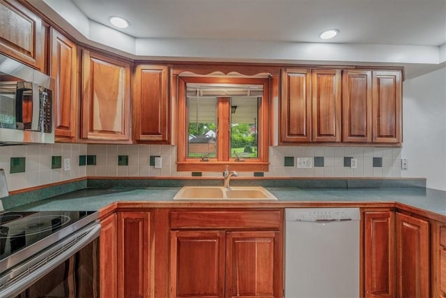 200 Spartan Dr, Bethel Park, PA 15102 - kitchen with stainless steel appliances, a sink, tasteful backsplash, and brown cabinetry