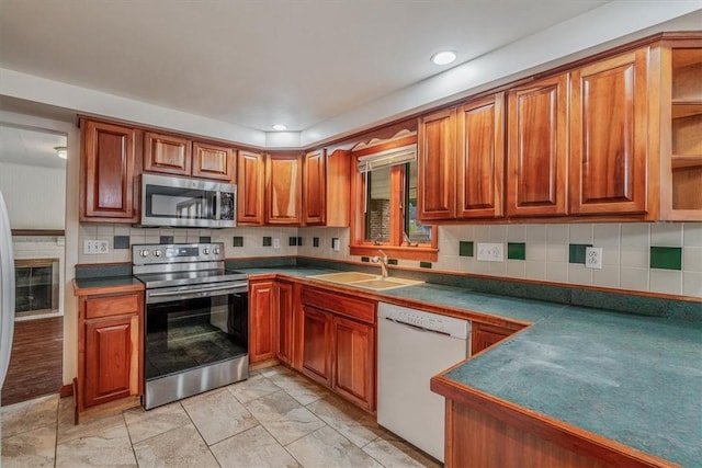 200 Spartan Dr, Bethel Park, PA 15102 - kitchen with stainless steel appliances, brown cabinetry, decorative backsplash, open shelves, and recessed lighting