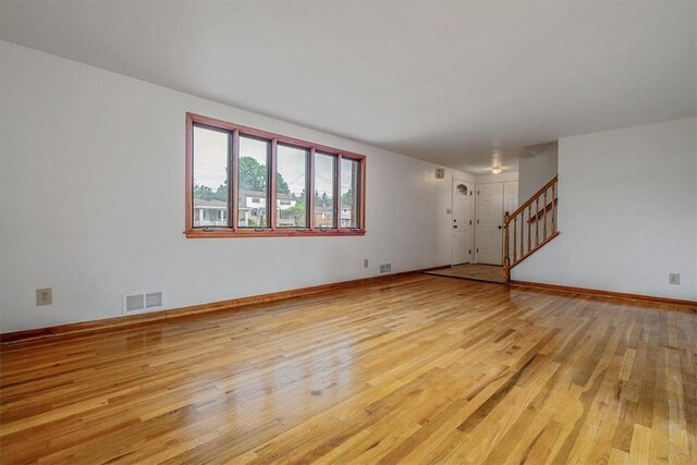 200 Spartan Dr, Bethel Park, PA 15102 - empty room with light wood-type flooring, stairway, and baseboards