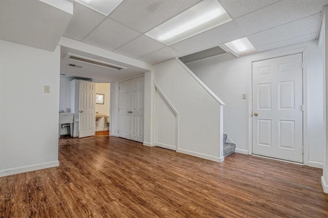 200 Spartan Dr, Bethel Park, PA 15102 - finished below grade area with stairway, wood finished floors, a paneled ceiling, and baseboards